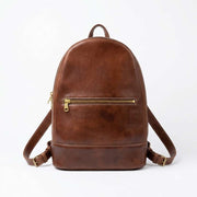 Brown Moroccan leather backpack standing upright, front view with flap and strap details
