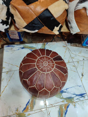 Dark brown round Moroccan leather pouf with cream flower and geometric embroidered detailing