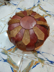 Round Moroccan pouf with alternating brown leather and tan hair-on-look patchwork panels