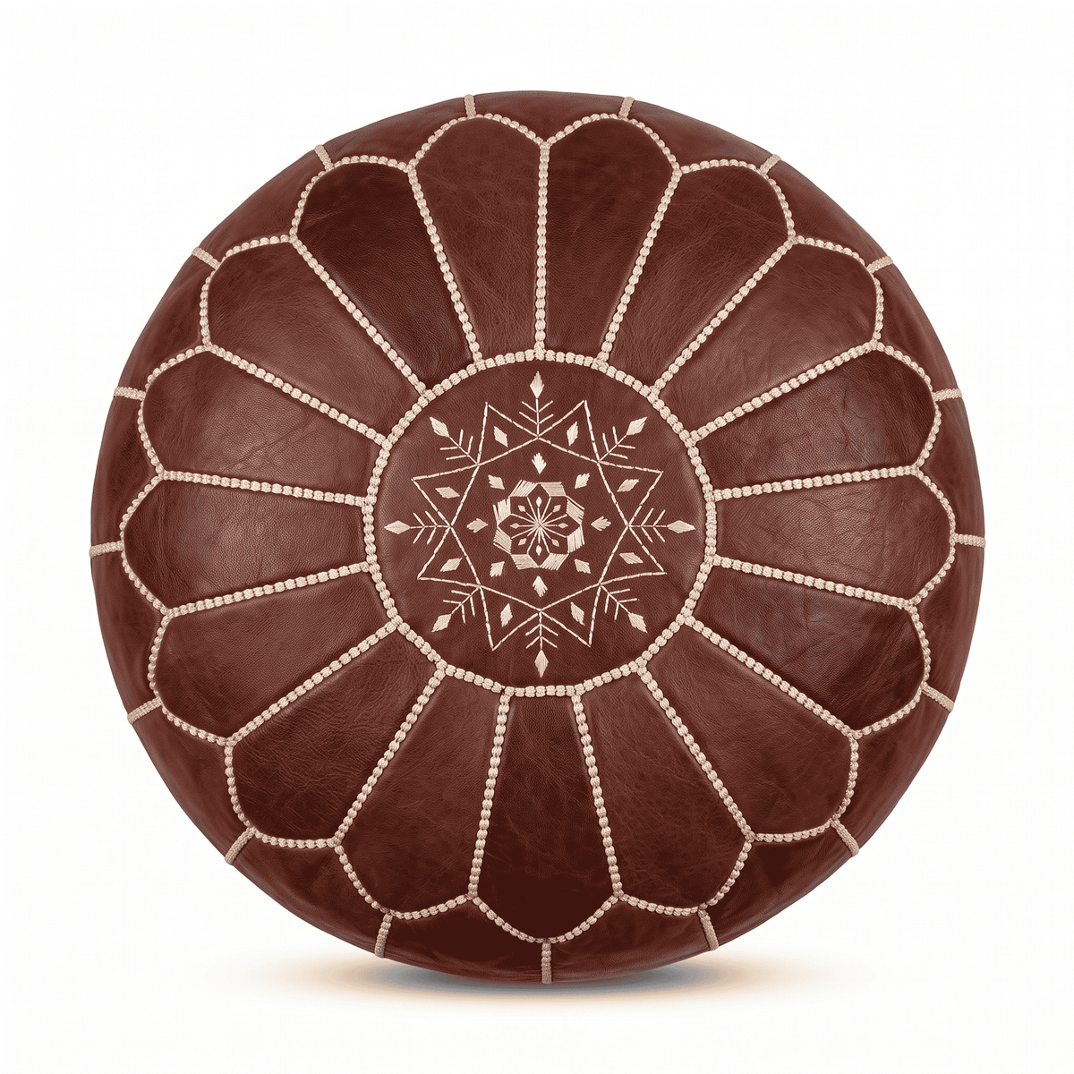 Dark brown Moroccan round leather pouf with cream floral embroidery against white